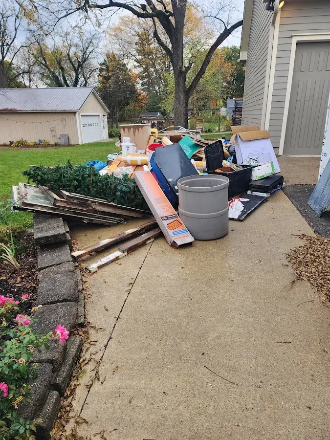 Dumpster being loaded with debris for Residential Dumpster Rental in Penfield